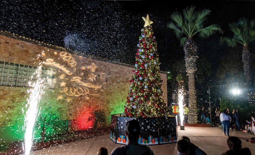 Christmas tree with festive decorations and snow